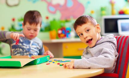 two boys playing at a table