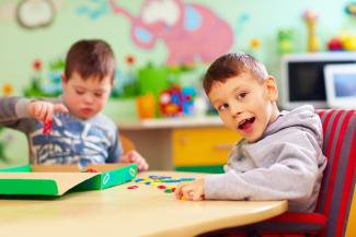 two boys playing at a table